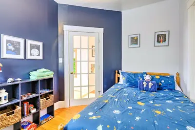 a blue bedroom with a bed with a teddy bear on it at Cincinnati Home with Deck and Private Hot Tub! in Cincinnati