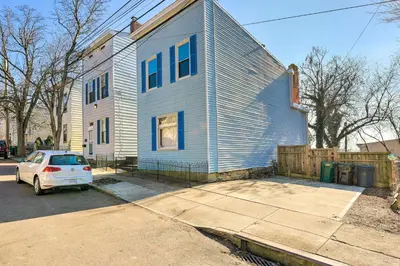 a white car parked in front of a house at Cincinnati Home with Deck and Private Hot Tub! in Cincinnati