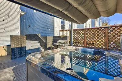 a hot tub on a deck with a house at Cincinnati Home with Deck and Private Hot Tub! in Cincinnati