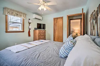 a bedroom with a large bed with a ceiling fan at Waterfront Lakeview Cottage with Dock and Lift! in Lakeview
