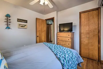 a bedroom with a bed and a tv on a dresser at Waterfront Lakeview Cottage with Dock and Lift! in Lakeview