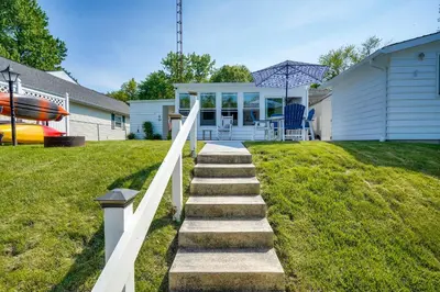 a stairway leading to a house with a boat at Waterfront Lakeview Cottage with Dock and Lift! in Lakeview