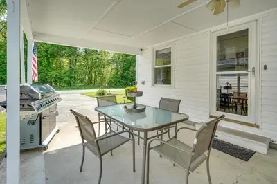 a patio with a table and chairs and a grill at Waterfront Lakeview Cottage with Dock and Lift! in Lakeview
