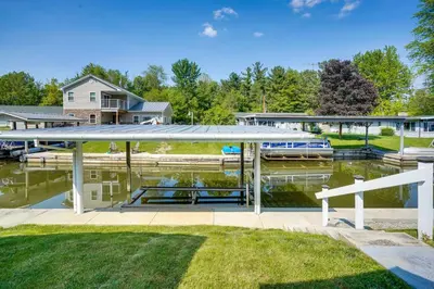 a house with a boat dock next to a marina at Waterfront Lakeview Cottage with Dock and Lift! in Lakeview