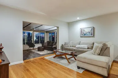 a living room with a couch and a table at Cincinnati Home, Patio with Downtown Views! in Cincinnati