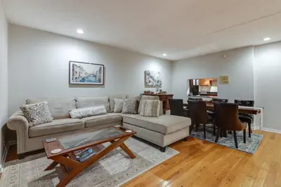 a living room with a couch and a table at Cincinnati Home, Patio with Downtown Views! in Cincinnati