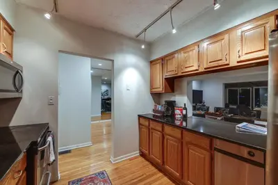 a kitchen with wooden cabinets and a counter top at Cincinnati Home, Patio with Downtown Views! in Cincinnati