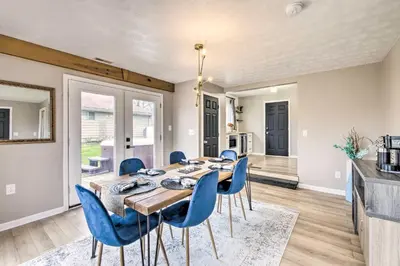 a dining room with a table and blue chairs at Cozy Ohio Retreat with Deck, Hot Tub and Grill! in Broadview Heights
