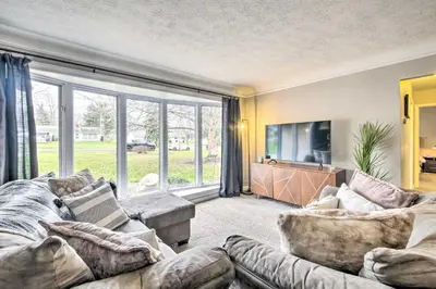 a living room with a couch and a tv at Cozy Ohio Retreat with Deck, Hot Tub and Grill! in Broadview Heights