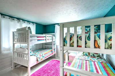 two white bunk beds in a room with blue walls at Vermilion River Home with Hot Tub and Private Dock! in Vermilion