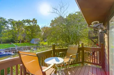 a porch with two chairs and a table on it at Vermilion River Home with Hot Tub and Private Dock! in Vermilion