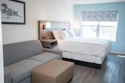 a bedroom with a bed and a couch at THE NEST in Greenfield