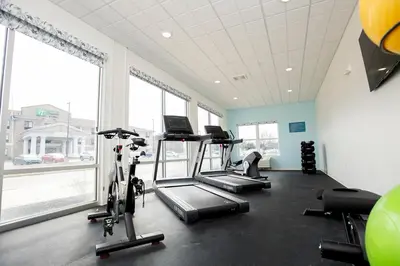 a gym with two treadmills and two exercise bikes at THE NEST in Greenfield