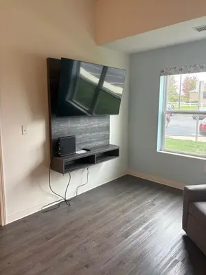 a living room with a flat screen tv on a wall at THE NEST in Greenfield