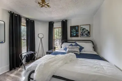 a bedroom with a bed with a blanket on it at The Akron Retreat: Modern 3-Bedroom Oasis in Akron