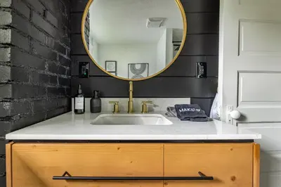a bathroom with a sink and a mirror at The Akron Retreat: Modern 3-Bedroom Oasis in Akron