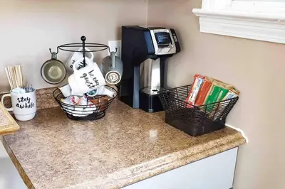 a kitchen counter with two baskets and a coffee maker at Cozy Cottage 10 mins to DTWN CLE Free Parking in Euclid