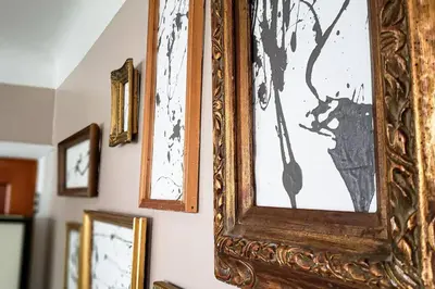 a wooden picture frame hanging on a wall at Cozy Cottage 10 mins to DTWN CLE Free Parking in Euclid