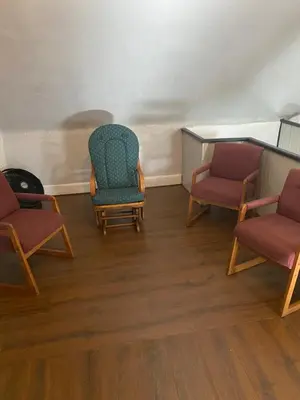 a waiting room with three chairs and a table at Awesome Attic Studio Private Room 3A in Cincinnati
