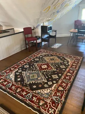 a rug on the floor in a room with a table at Awesome Attic Studio Private Room 3A in Cincinnati