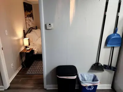 a hallway with a room with a bed and a trash can at Lovely Two Bedroom Home- Close to DT Greenfield in Greenfield