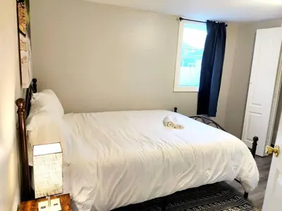 a bedroom with a white bed and a window at Lovely Two Bedroom Home- Close to DT Greenfield in Greenfield