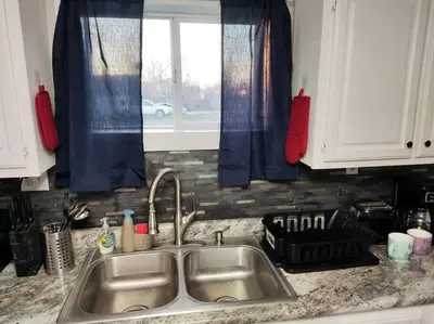 a kitchen counter with a sink and a window at Lovely Two Bedroom Home- Close to DT Greenfield in Greenfield
