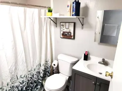 a bathroom with a toilet and a sink at Lovely Two Bedroom Home- Close to DT Greenfield in Greenfield