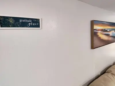 a sign on a wall in a room with a couch at Lovely Two Bedroom Home- Close to DT Greenfield in Greenfield