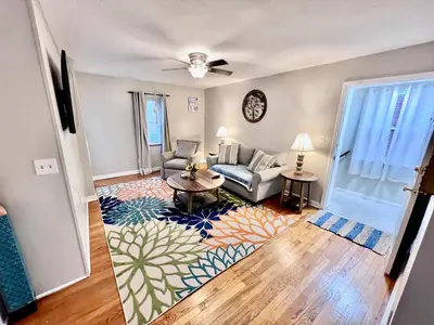 a living room with a couch and a table at Comfy 2nd Floor Apartment in Quiet Neighborhood 13 Min to Dwntwn in Cincinnati