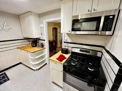 a kitchen with a stove and a microwave at Comfy 2nd Floor Apartment in Quiet Neighborhood 13 Min to Dwntwn in Cincinnati