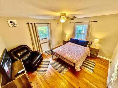 a bedroom with a bed and a chair at Comfy 2nd Floor Apartment in Quiet Neighborhood 13 Min to Dwntwn in Cincinnati