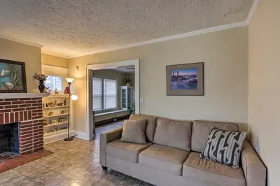 a living room with a couch and a fireplace at Lakewood Home with Yard about 8 Mi to Cleveland! in Lakewood