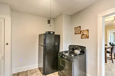 a kitchen with a stove and a refrigerator at Lakewood Home with Yard about 8 Mi to Cleveland! in Lakewood