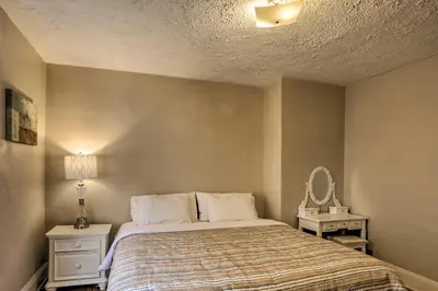a bedroom with a bed and a mirror at Lakewood Home with Yard about 8 Mi to Cleveland! in Lakewood