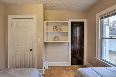 a bedroom with a bed and a door and a window at Lakewood Home with Yard about 8 Mi to Cleveland! in Lakewood