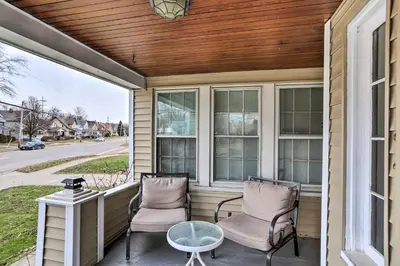 a screened porch with two chairs and a table at Lakewood Home with Yard about 8 Mi to Cleveland! in Lakewood