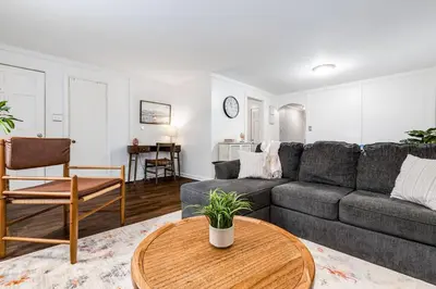 a living room with a couch and a table at City Boho ✦ New Kitchen ✦ King Bed ✦ WFH in Bexley