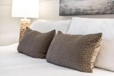 a white bed with two pillows on it at City Boho ✦ New Kitchen ✦ King Bed ✦ WFH in Bexley