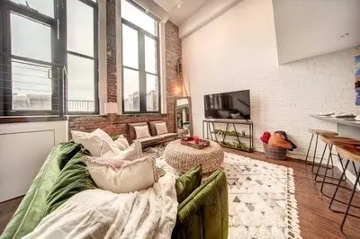a living room with a couch and a tv at Waterfront Cleveland Apt about 1 Mi to Downtown in Cleveland