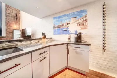 a kitchen with white cabinets and a sink at Waterfront Cleveland Apt about 1 Mi to Downtown in Cleveland