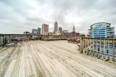 a wooden deck with a city skyline in the background at Waterfront Cleveland Apt about 1 Mi to Downtown in Cleveland