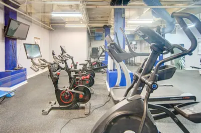 a gym with several exercise bikes in a row at Waterfront Cleveland Apt about 1 Mi to Downtown in Cleveland