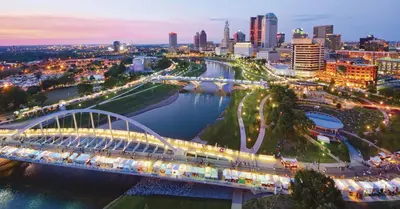 a bridge over a river with a city in the background at King Size with OSU Theme! in Columbus