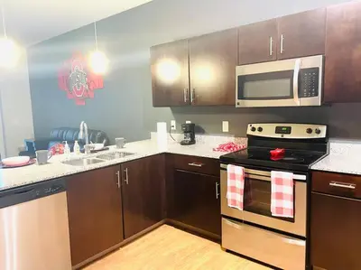 a kitchen with a stove and a microwave at King Size with OSU Theme! in Columbus