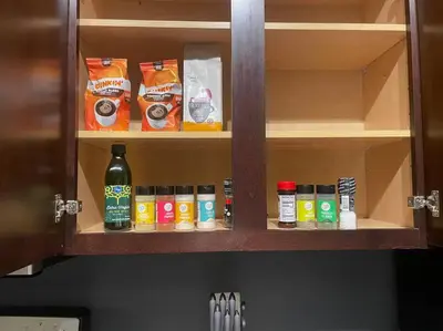 a cabinet with bottles of food and spices at King Size with OSU Theme! in Columbus