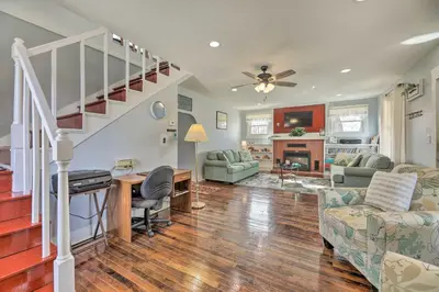 a living room with a staircase and a living room at Manchester Getaway on Ohio River Scenic Byway in Manchester