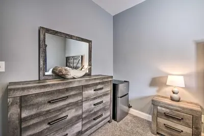 a bedroom with a dresser with a mirror on it at Waterfront Home on Lake Milton Dock, Hot Tub in Lake Milton