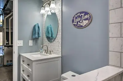 a bathroom with a sink and a mirror at Waterfront Home on Lake Milton Dock, Hot Tub in Lake Milton