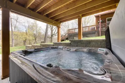 a large hot tub in a patio with a deck at Waterfront Home on Lake Milton Dock, Hot Tub in Lake Milton